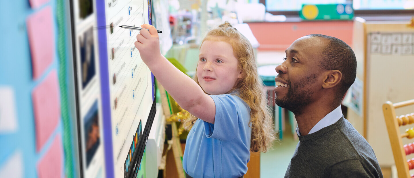 Teacher and student using a Promethean ActivPanel in the classroom.