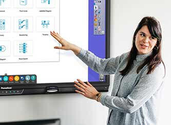 Woman presenting in an office using the Activpanel interactive display. 