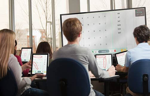 students using tablets in the classroom that are mirroring the interactive display screen.