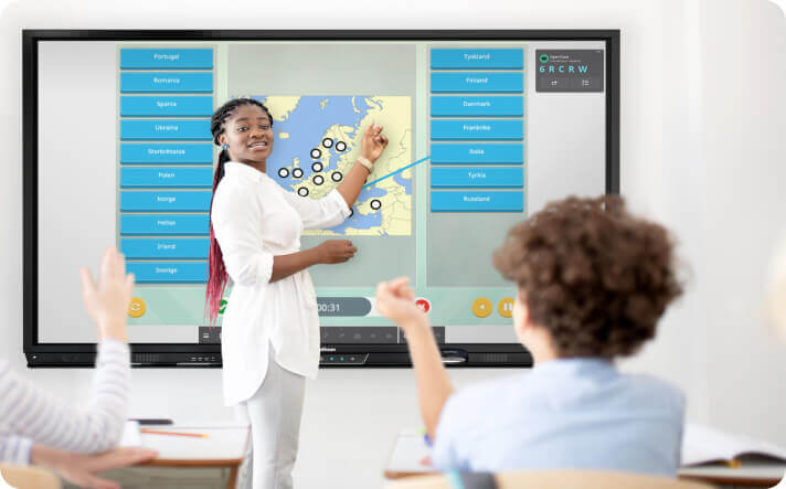 Teacher using the ActivPanel interactive display to present a lesson in the classroom.