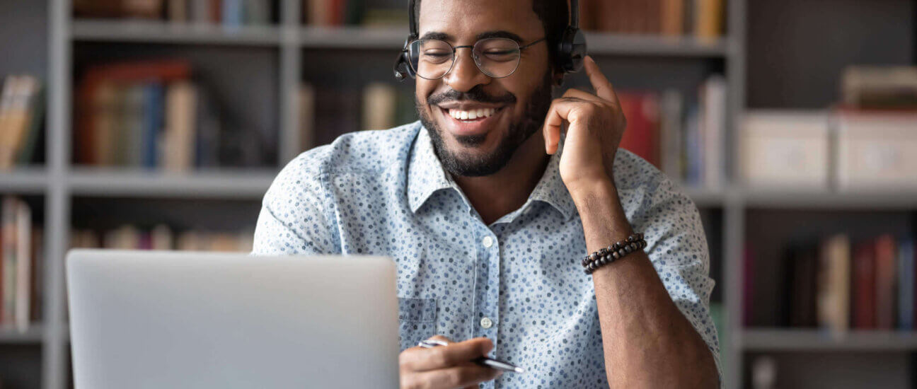 man talking into headset smiling