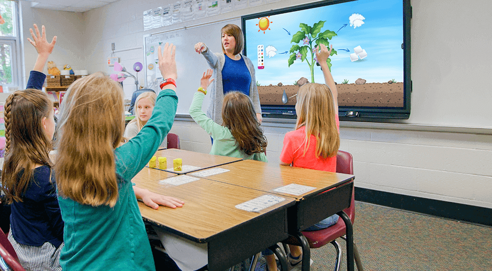 Kids raising hands in classroom to be called on