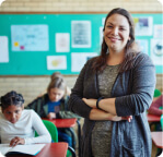 teacher smiling in front of her classroom