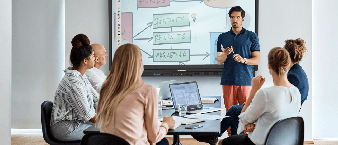 Man discussing work with co-workers using a Promethean ActivPanel