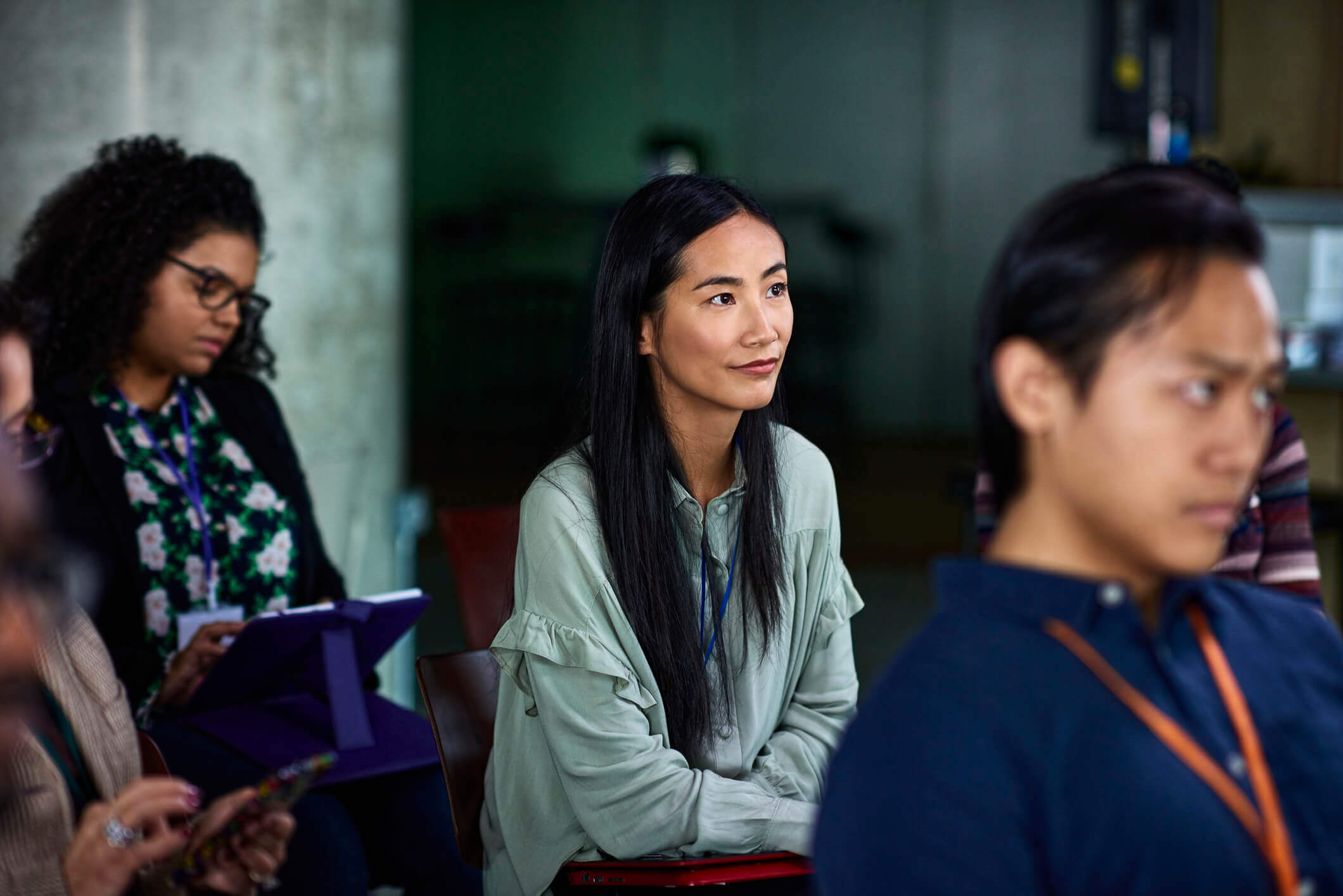 A smiling woman attends a conference