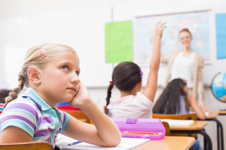 Student looking away from teacher in class "zoning" out.
